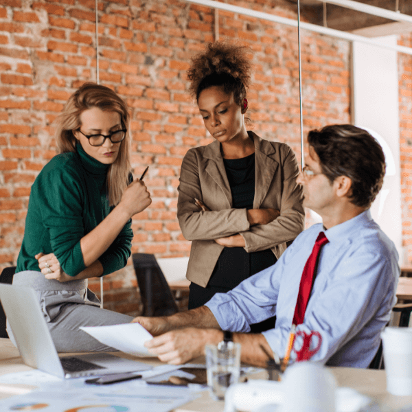 Three workers discussing energy efficiency in the workplace