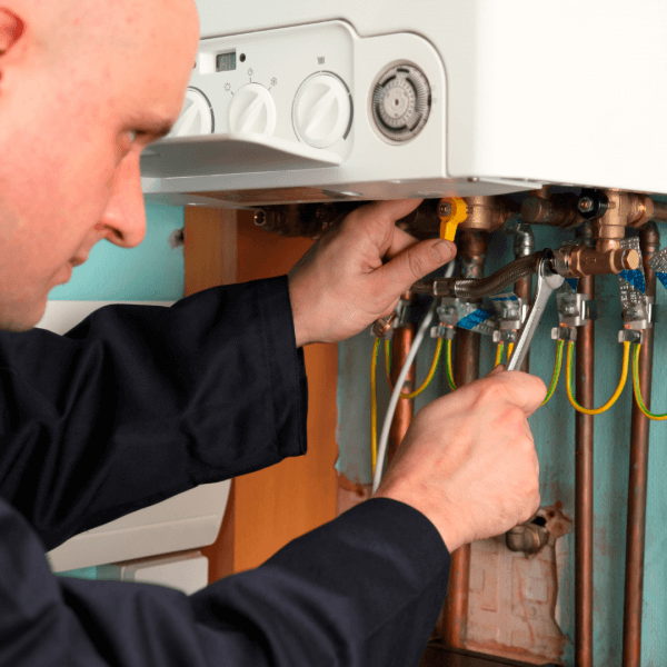 A boiler being removed, soon to be replaced by a heat pump